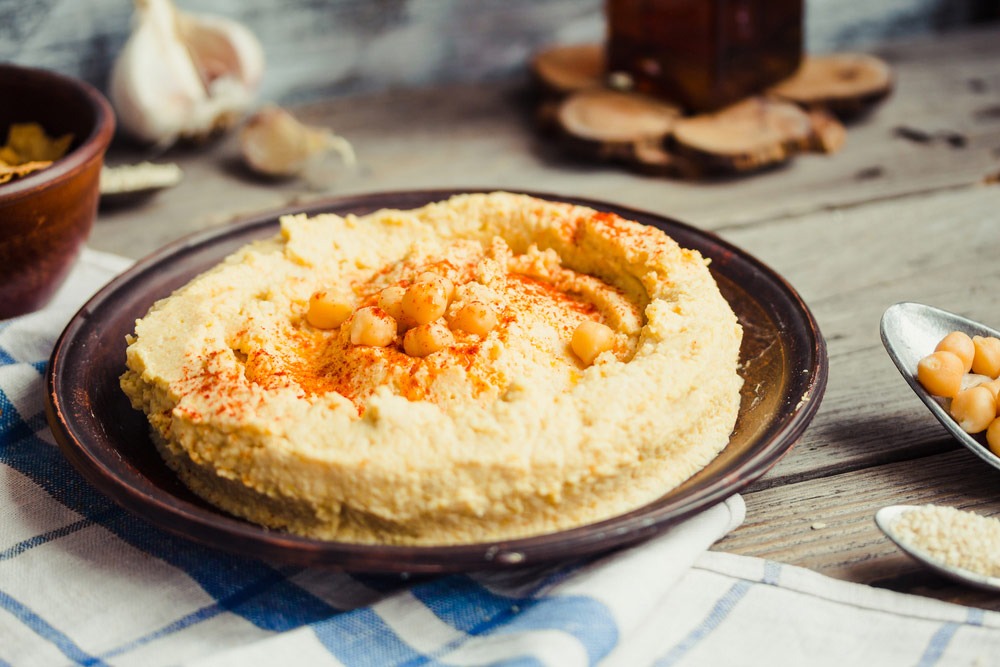 hummus-with-chickpeas-on-a-plate-with-some-paprika-spice12018-07-12-09-37-32